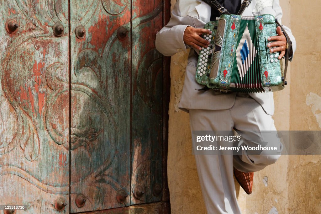 Hispanic man playing accordion