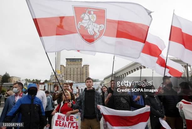 Belarusians hold former national Belarusian flags at the Independence Square during the protest. Members of Belarusian Diaspora in Ukraine took part...