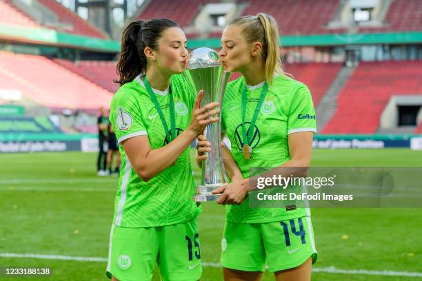 Ingrid Syrstad Engen of VfL Wolfsburg and Fridolina Rolfoe of VfL Wolfsburg kisses the trophy after winning the Women's DFB Cup Final match between...