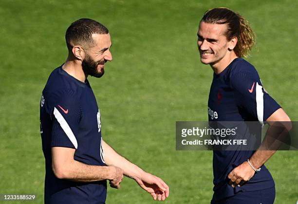 France's forward Karim Benzema speaks with France's forward Antoine Griezmann during a training session ahead of France's friendly football match...