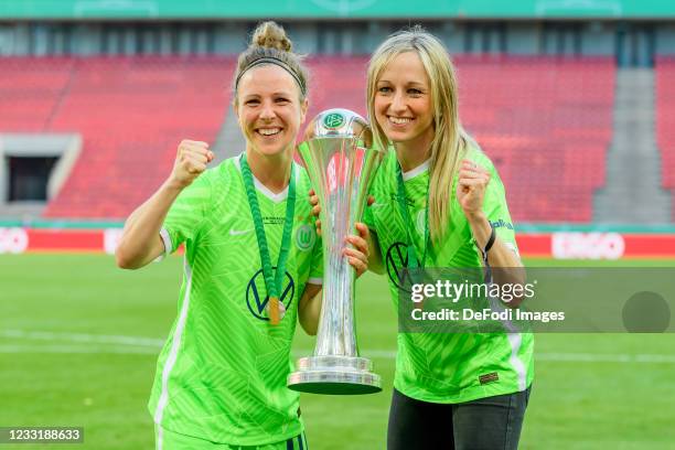 Svenja Huth of VfL Wolfsburg and Lena Goeßling of VfL Wolfsburg with the trophy after winning the Women's DFB Cup Final match between Eintracht...