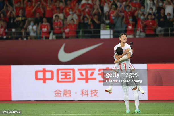 Alan Douglas Borges de Carvalho of China celebrates a goal with teammate Wei Shihao during the 2022 FIFA World Cup Asian Qualifiers Group A match...