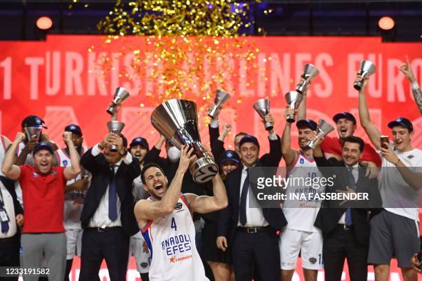 Anadolu Efes Istanbul's Dogus Balbay holds up the trophy as he celebrates with his team after the Basketball Euroleague Final Four championship final...