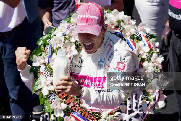 Helio Castroneves celebrates after becoming the fourth driver in history to win the Indianapolis 500 auto race four times at Indianapolis Motor...