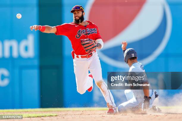 Amed Rosario of the Cleveland Indians forces out Marcus Semien of the Toronto Blue Jays at second base and throws out Bo Bichette at first base to...