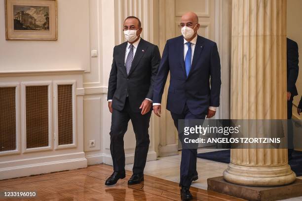 Greek Foreign Minister Nikos Dendias and his Turkish counterpart Mevlut Cavusoglu arrive for a meeting at the Greek Ministry of Foreign Affairs in...
