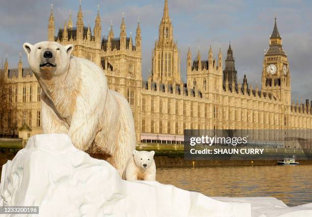 Life-like 16ft high sculpture of an iceberg featuring a stranded polar bear and its cub is pictured on the River Thames in London, on January 26,...