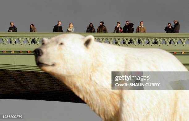 Life-like 16ft high sculpture of an iceberg featuring a stranded polar bear and its cub is pictured on the River Thames in London, on January 26,...