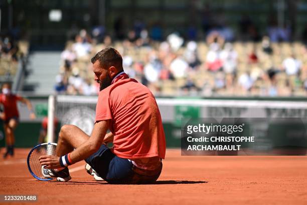 France's Benoit Paire reacts at the end of his men's singles first round tennis match against Norway's Casper Ruud on Day 2 of The Roland Garros 2021...