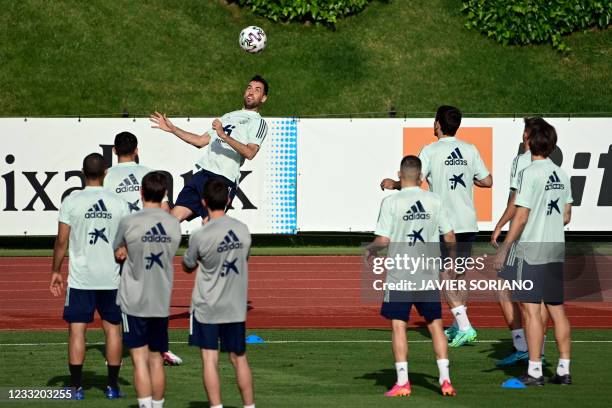 Spain's midfielder Sergio Busquets heads the ball during Spain's national football team's first training session on May 31, 2021 at the Ciudad del...