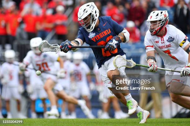 Virginia Cavaliers mid Petey LaSalla sweeps the ball away from Maryland Terrapins face-off Justin Shockey during the Division I Men's Lacrosse...