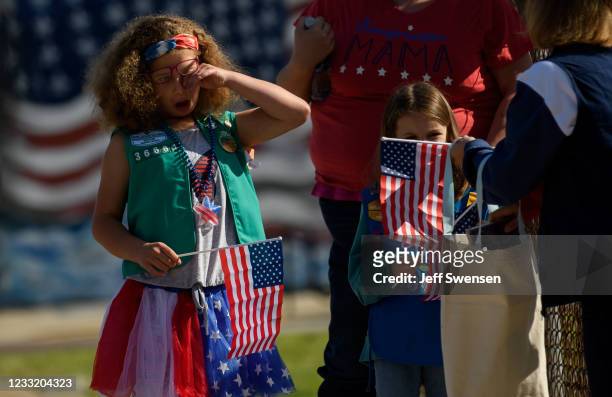 Girl Scout wipes away the sleep from her eyes before the start of the 2021 Oakmont-Verona Memorial Day Parade on May 31, 2021 in Oakmont,...