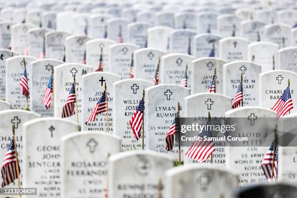 American flags have been placed next to the headstones in Arlington National Cemetery in observance of Memorial Day on May 31, 2021 in Arlington,...