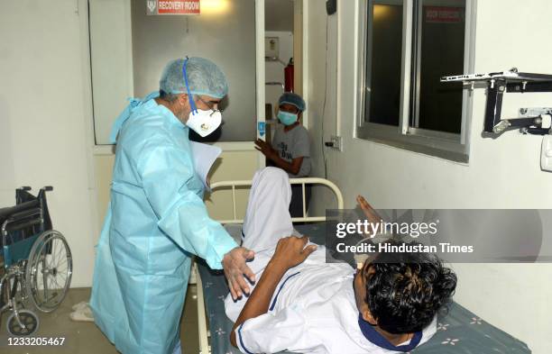 Dr. BP Tyagi examines a person before Functional Endoscopic Sinus surgery due to black and yellow fungus infection, at Harsh ENT Hospital on May 31,...