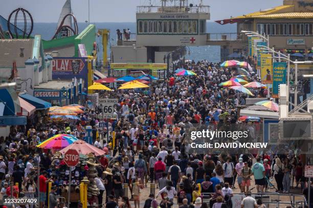 People fill the Santa Monica Pier as crowds gather on Memorial Day as shutdowns are relaxed more than a year after Covid-19 pandemic shutdowns began,...