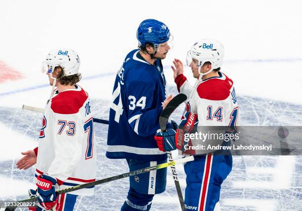 Auston Matthews of the Toronto Maple Leafs shakes hands with Nick Suzuki of the Montreal Canadiens after being defeated by the Montreal Canadiens in...
