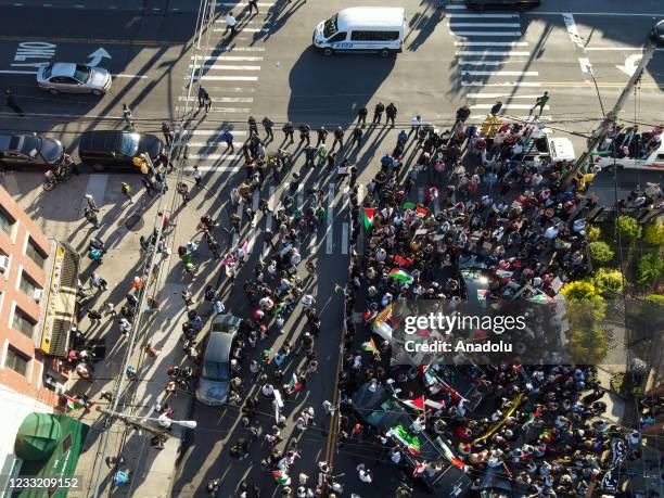 Drone photo shows hundreds holding banners and Palestinian flags gather at the Little Yemen district of Bronx and take streets to protest Israeli...