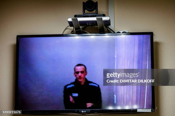 Jailed Kremlin critic Alexei Navalny appears on screen via a video link from prison during a court hearing, at a court in the town of Petushki some...