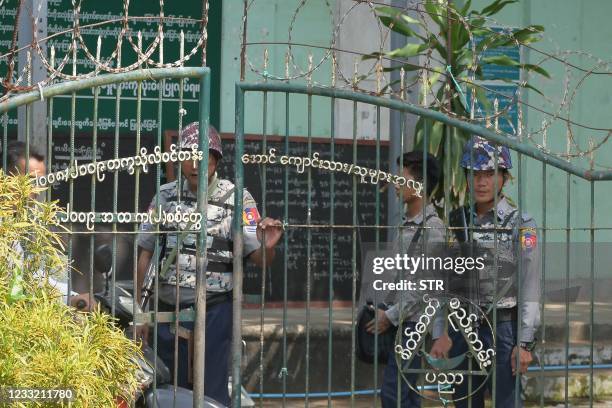 Armed police are posted at the entrance of a school in Sittwe, capital of western Rakhine State on June 1, 2021. - Schools in Myanmar opened on June...