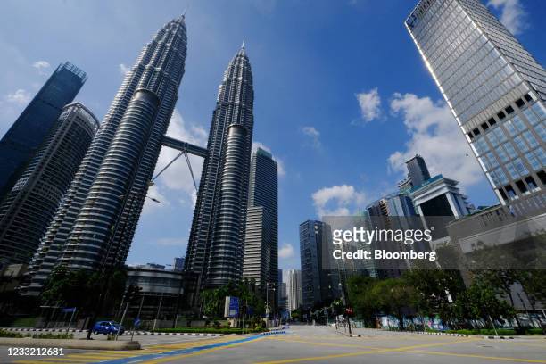 The streets around the Petronas Twin Towers, left, are deserted in Kuala Lumpur, Malaysia, on Tuesday, June 1, 2021. Malaysia unveiled a 40 billion...