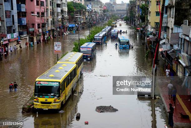 Citizens and Vehicles try to moves through the waterlogged streets of Dhaka after heavy rainfalls caused almost-standstill, on June 1, 2021. After...