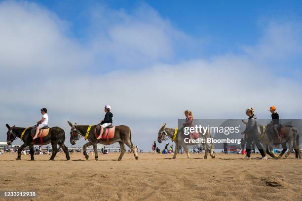 Children ride donkeys along the beach in Skegness, U.K., on Monday, May 31, 2021. U.K. Health Secretary Matt Hancock said people who want to go on...