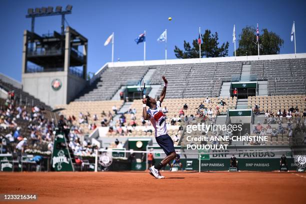 France's Gael Monfils serves the ball to Spain's Albert Ramos-Vinolas during their men's singles first round tennis match on Day 3 of The Roland...