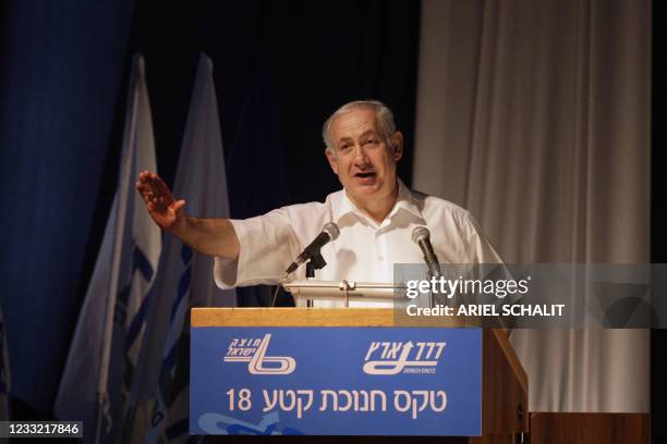 Israeli Prime Minister Benjamin Netanyahu gestures as he speaks during a ceremony marking the new Trans-Israel highway interchange opening in Ein...