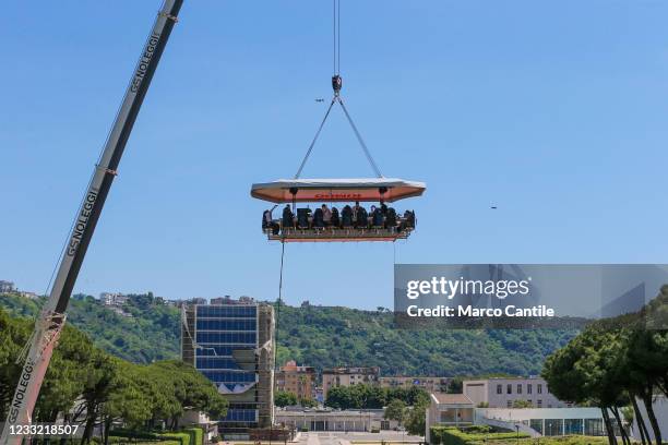View of "Dinner in the Sky", a suspended platform 50 meters above the ground, in Naples in the Mostra d'Oltremare, on which 22 people eat food...