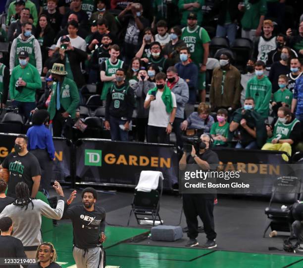 Fans watch Kyrie Irving of the Brooklyn Nets during pre-game warmups. The Boston Celtics host the Brooklyn Nets in Game Four of their first round NBA...