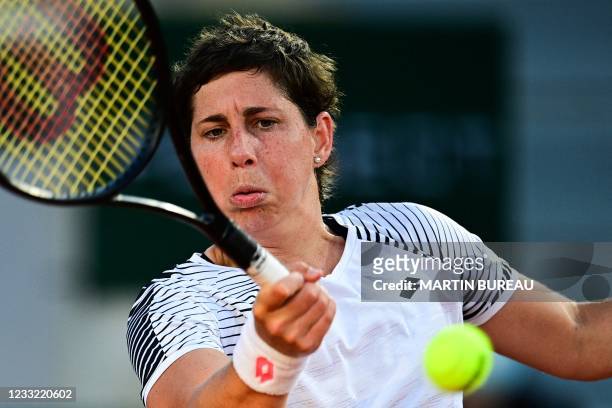 Spain's Carla Suarez Navarro returns the ball to Sloane Stephens of the US during their women's singles first round tennis match on Day 3 of The...