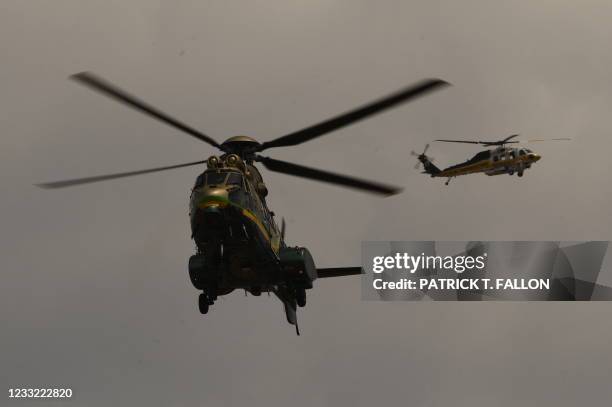 Los Angeles Sheriff Department Rescue 5 Super Puma helicopter circles over a burning house of a suspected gunman of a shooting at a fire station on...