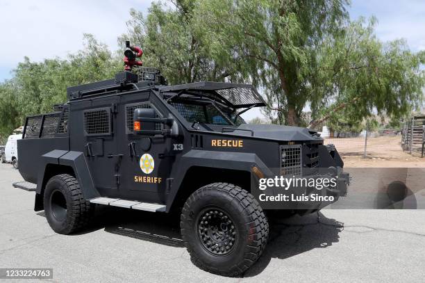 Sheriff's Department vehicle drives up Bent Spur Drive in Acton near a house where a suspect in a shooting was believed to be barricaded on Tuesday,...