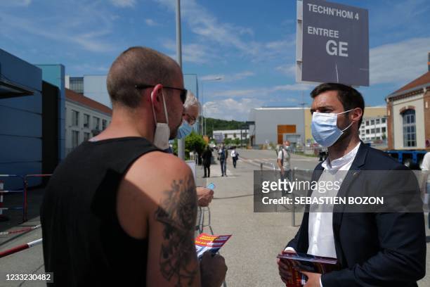 French far-right Rassemblement National candidate for the Bourgogne in France's June 2021 regional elections, Julien Odoul speaks with pedestrians as...