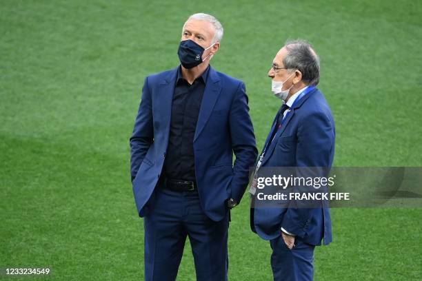 France's coach Didier Deschamps chats with French Football Federation Noel Le Graet on the pitch before the friendly football match between France...