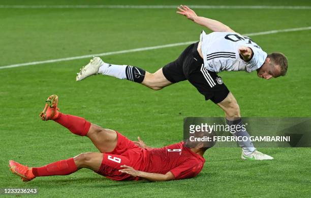 Denmark's forward Martin Braithwaite and Germany's defender Lukas Klostermann vie during the friendly football match Germany v Denmark in Innsbruck,...