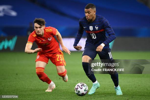 France's forward Kylian Mbappe is challenged by Wales' midfielder Dylan Levitt during the friendly football match between France and Wales at the...