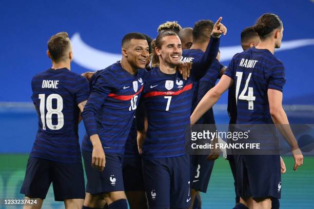 France's forward Antoine Griezmann celebrates with France's forward Kylian Mbappe after scoring his team's second goal during the friendly football...