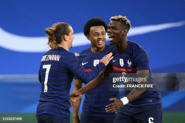 France's forward Antoine Griezmann celebrates with France's midfielder Paul Pogba after scoring his team's second goal during the friendly football...