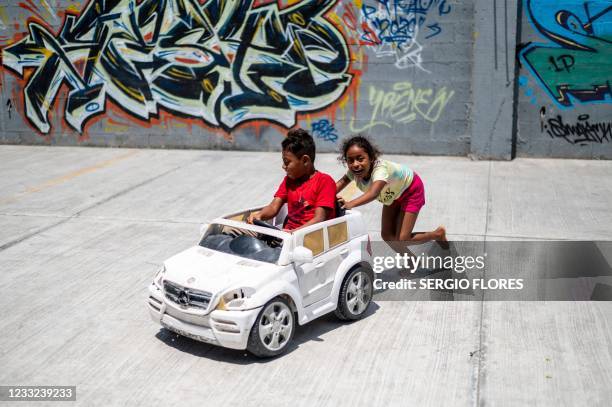 Children play at a migrant shelter on May 26, 2021 in Matamoros, Mexico. - Once, Abraham Barberi was known as the "pastor of rappers," host of...