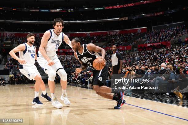 Kawhi Leonard of the LA Clippers handles the ball during the game as Boban Marjanovic of the Dallas Mavericks plays defense during Round 1, Game 5 of...