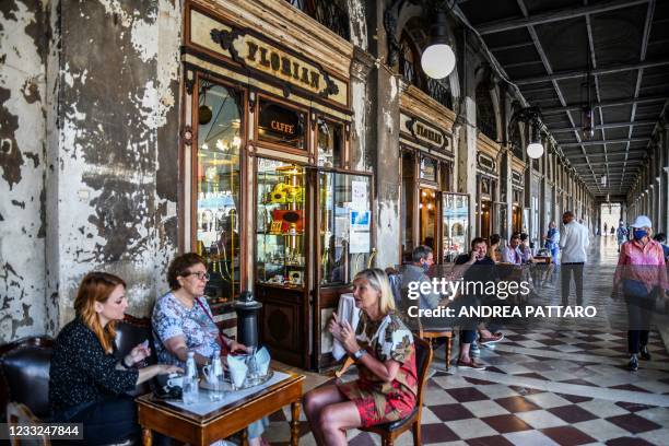 People enjoy a drink at cafe Florian in Venice on June 03, 2021.