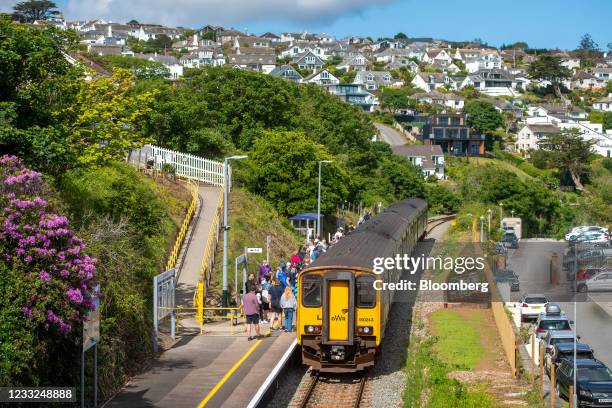 Travelers board a train from the platform at the Carbis Bay train station, near the venue for the upcoming Group of Seven leaders summit, in Carbis...