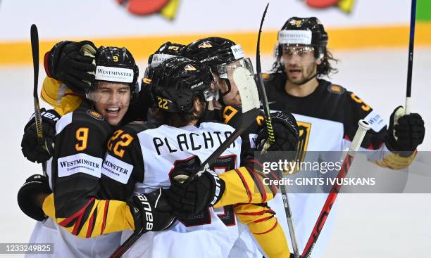 Germany's players celebrate during the IIHF Men's Ice Hockey World Championships quarter final match between Switzerland and Germany, at the Olympic...