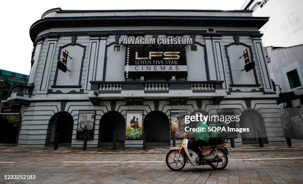 Food delivery man rides past a closed cinema during lockdown. Malaysias government re-imposed a total nationwide lockdown from June 1st -14th to head...