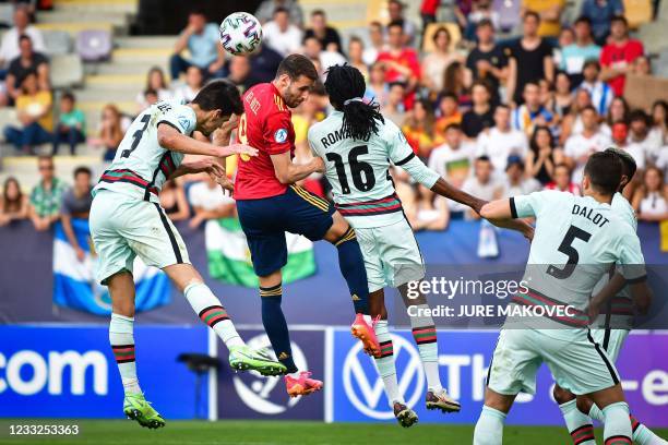 Spains forward Abel Ruiz fights for the ball with Portugals defender Diogo Leite and Portugal's midfielder Romario Baro during the 2021 UEFA European...