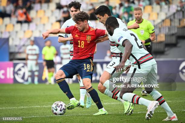 Spains forward Javier Puado fights for the ball with Portugals defender Diogo Leite and Portugal's defender Abdu Conte during the 2021 UEFA European...