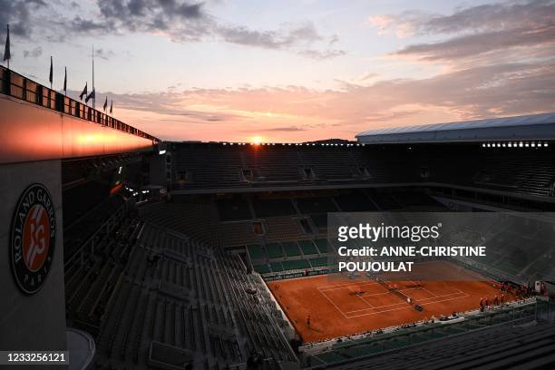 Members of the ground staff prepare the Philippe Chatrier court ahead of a singles second round tennis match on Day 5 of The Roland Garros 2021...