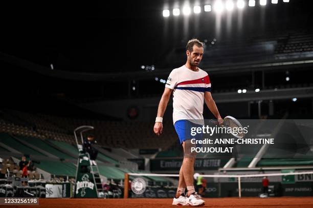 France's Richard Gasquet reacts as he plays against Spain's Rafael Nadal during their men's singles second round tennis match on Day 5 of The Roland...