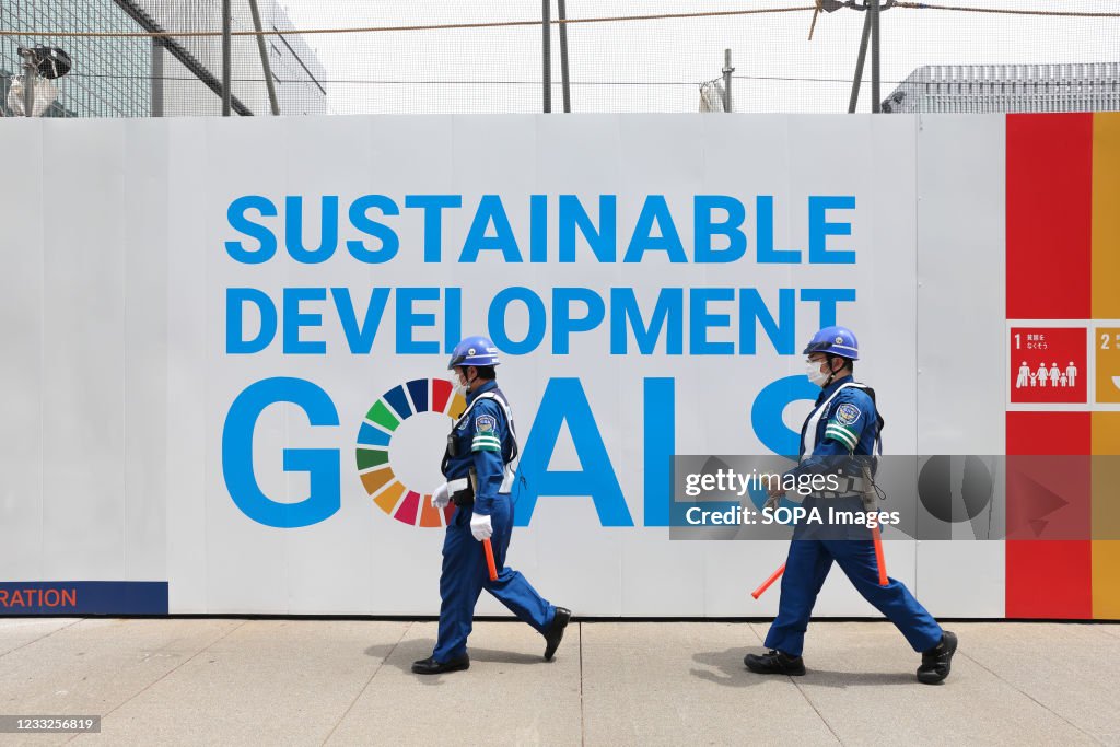 Construction site guards wearing masks as a preventive...